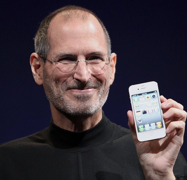 Steve Jobs holds the first iPhone